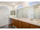 Elegant bathroom with double sinks, oak cabinetry, and large mirrors at 12665 Wolff St, Broomfield, CO 80020