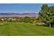 Golf course with mountain backdrop and homes in background at 342 Driftwood Cir, Lafayette, CO 80026