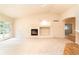 Spacious living room featuring hardwood and carpet flooring, a fireplace, and access to patio at 342 Driftwood Cir, Lafayette, CO 80026