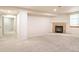 Finished basement with fireplace and neutral carpeting at 342 Driftwood Cir, Lafayette, CO 80026