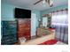 Bedroom with a large dresser and a flat-screen TV at 11761 E Canal Dr, Aurora, CO 80011