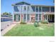 Updated townhome exterior, featuring a well-maintained lawn and landscaping at 11761 E Canal Dr, Aurora, CO 80011