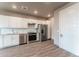 Modern kitchen with white cabinets and stainless steel appliances at 12983 W Ida Ave # 200, Littleton, CO 80127