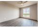Bright bedroom featuring a large window and hardwood floors at 12983 W Ida Ave # 200, Littleton, CO 80127
