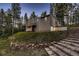 Modern home with stone stairs and wooded area at 6100 Apache Dr, Larkspur, CO 80118