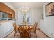 Bright dining area with wood table and chairs, near kitchen at 11355 W 84Th Pl # D, Arvada, CO 80005