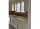 Kitchen with white cabinets and double sink at 8536 Eaton St, Arvada, CO 80003