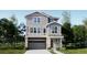 Two-story home with gray siding, stone accents, and a two-car garage at 6726 E 149Th Dr, Thornton, CO 80602