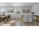 Dining area with a wooden table and white chairs near the living room at 8971 Utah Ct, Thornton, CO 80229