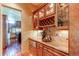 Butlers pantry with wine rack and granite countertops at 5764 Amber Ridge Dr, Castle Pines, CO 80108