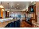 Open kitchen with stainless steel appliances and hardwood floors at 5764 Amber Ridge Dr, Castle Pines, CO 80108