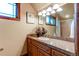 Bathroom with granite countertop, wood cabinets, and shower at 5764 Amber Ridge Dr, Castle Pines, CO 80108