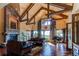 Spacious living room with a stone fireplace, hardwood floors, and large windows at 5764 Amber Ridge Dr, Castle Pines, CO 80108