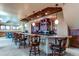 Basement bar with granite countertop and custom cabinetry at 5764 Amber Ridge Dr, Castle Pines, CO 80108