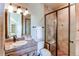 Bathroom with granite countertop, tiled shower, and a sink at 5764 Amber Ridge Dr, Castle Pines, CO 80108