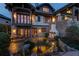 Backyard with pond, stone fireplace and patio seating at 5764 Amber Ridge Dr, Castle Pines, CO 80108
