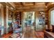 Library with built-in shelves and a view into the adjacent living area at 5764 Amber Ridge Dr, Castle Pines, CO 80108