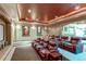 Home theater with tiered seating and large screen at 5764 Amber Ridge Dr, Castle Pines, CO 80108