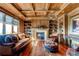 Cozy library with built-in shelves, a fireplace, and comfortable seating at 5764 Amber Ridge Dr, Castle Pines, CO 80108