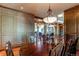 Formal dining room with hardwood floors, chandelier, and large windows at 5764 Amber Ridge Dr, Castle Pines, CO 80108