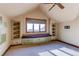 Upstairs bedroom with built-in shelves and window seat at 5764 Amber Ridge Dr, Castle Pines, CO 80108