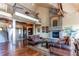 Grand living room with high ceilings, a stone fireplace, and hardwood floors at 5764 Amber Ridge Dr, Castle Pines, CO 80108