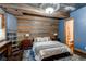 Basement bedroom with wood-paneled walls and ensuite bathroom at 5764 Amber Ridge Dr, Castle Pines, CO 80108