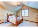 Bedroom with wooden bed frame and adjacent bathroom at 5764 Amber Ridge Dr, Castle Pines, CO 80108
