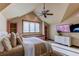 Bright bedroom with a queen bed and a built-in window seat at 5764 Amber Ridge Dr, Castle Pines, CO 80108