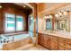 Spa-like bathroom with soaking tub and custom cabinetry at 5764 Amber Ridge Dr, Castle Pines, CO 80108