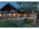 House exterior with fire pit and seating area at dusk at 5764 Amber Ridge Dr, Castle Pines, CO 80108