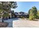 Stunning two-story home with a circular driveway and landscaping at 5764 Amber Ridge Dr, Castle Pines, CO 80108