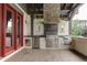 Outdoor kitchen with grill, refrigerator, and stone countertops at 5764 Amber Ridge Dr, Castle Pines, CO 80108