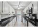 Modern kitchen with white cabinets, granite countertops and appliances at 1313 Steele St # 801, Denver, CO 80206