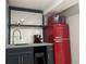 Charming basement kitchenette with red refrigerator and espresso machine at 13722 W 67Th Pl, Arvada, CO 80004