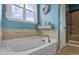 Relaxing bathroom with soaking tub and neutral color scheme at 17027 Pale Anemone St, Parker, CO 80134