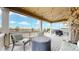 Covered back patio with string lights and seating at 27656 E Alder Dr, Aurora, CO 80016