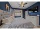 Main bedroom with navy walls, king bed and large TV at 15536 W 64Th Loop # A, Arvada, CO 80007