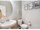 Clean and modern half bathroom with a pedestal sink and toilet at 944 Mcmurdo Cir, Castle Rock, CO 80108