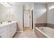 Bathroom with double vanity and a soaking tub at 944 Mcmurdo Cir, Castle Rock, CO 80108