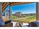 Covered patio with fire pit and wicker seating, overlooking backyard at 944 Mcmurdo Cir, Castle Rock, CO 80108