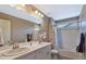 Bathroom with double vanity, bathtub, and shower at 944 Mcmurdo Cir, Castle Rock, CO 80108