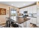 Modern kitchen with white cabinets, stainless steel appliances and a breakfast bar at 944 Mcmurdo Cir, Castle Rock, CO 80108