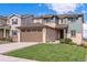 Two-story house with a brown garage door and nicely landscaped yard at 944 Mcmurdo Cir, Castle Rock, CO 80108