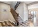 Modern staircase with wood railings and light gray carpeting at 944 Mcmurdo Cir, Castle Rock, CO 80108