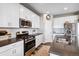Modern kitchen with white cabinets, stainless steel appliances, and a spacious layout at 944 Mcmurdo Cir, Castle Rock, CO 80108