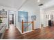 Upstairs hallway with wood floors and access to bedrooms at 14189 St Paul St, Thornton, CO 80602