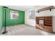 Bedroom with green accent wall, carpet, and built-in shelving at 6338 W 92Nd Pl, Westminster, CO 80031