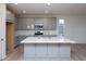 Modern kitchen with gray cabinets, quartz countertops, and island at 1837 Water Birch Way, Castle Rock, CO 80108