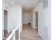 Bright and spacious hallway with light wood laminate flooring at 1837 Water Birch Way, Castle Rock, CO 80108